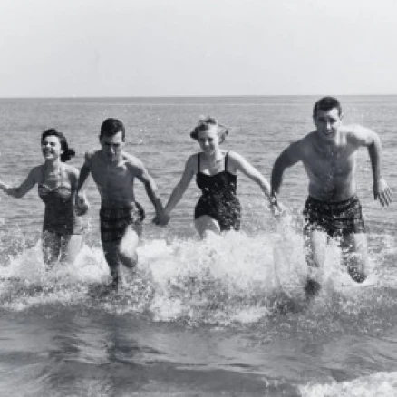 Two young couples running in water Poster Print (24 x 36)