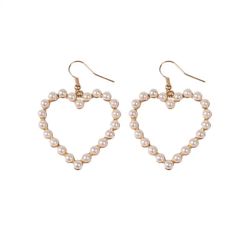 

Lovely hearts of pearl earrings Hot melting Lovely hollow out hearts of pearl earrings ear clip Popular peach heart pendant