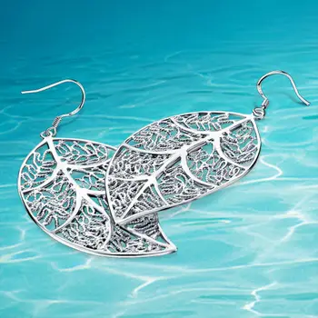 

Fashion ladies earrings. 925 sterling silver pendant earrings hollow out leaves. Fine carving. Elegant lovely woman earrings