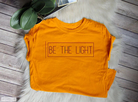

Sugarbaby Be The Light T-shirt Christian Graphic Tee gift for women Faith T shirt Short Sleeve Unisex Fashion Summer T shirt