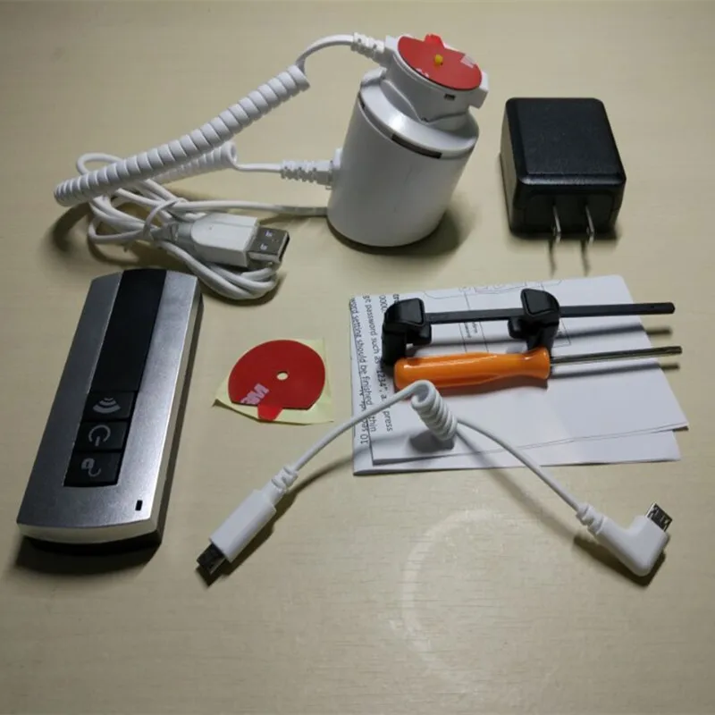 

sold in 10 set smart phone retail security display remote control alarm and charging holder with metal adjustable clamps