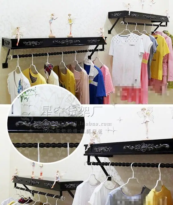 Clothes hangers show. On the wall clothing. Clothing store shelves of carve patterns or designs on woodwork hanging.