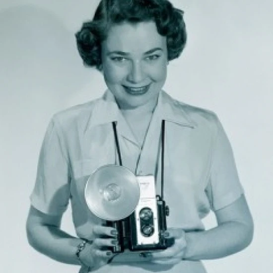 Studio portrait of woman holding video camera Poster Print (18 x 24)