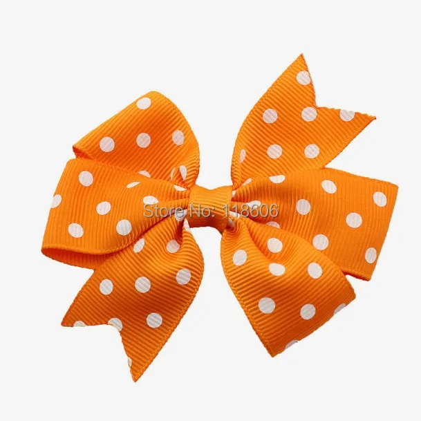 Orange Polka dot pinwheel hair bow.jpg