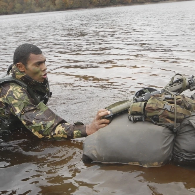 A soldier participates in a river crossing during Exercise Cambrian Patrol Poster Print (34 x 22)