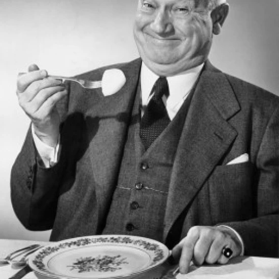 Portrait of a businessman eating food Poster Print (24 x 36)