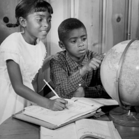 Girl and her brother looking at a globe Poster Print (18 x 24)