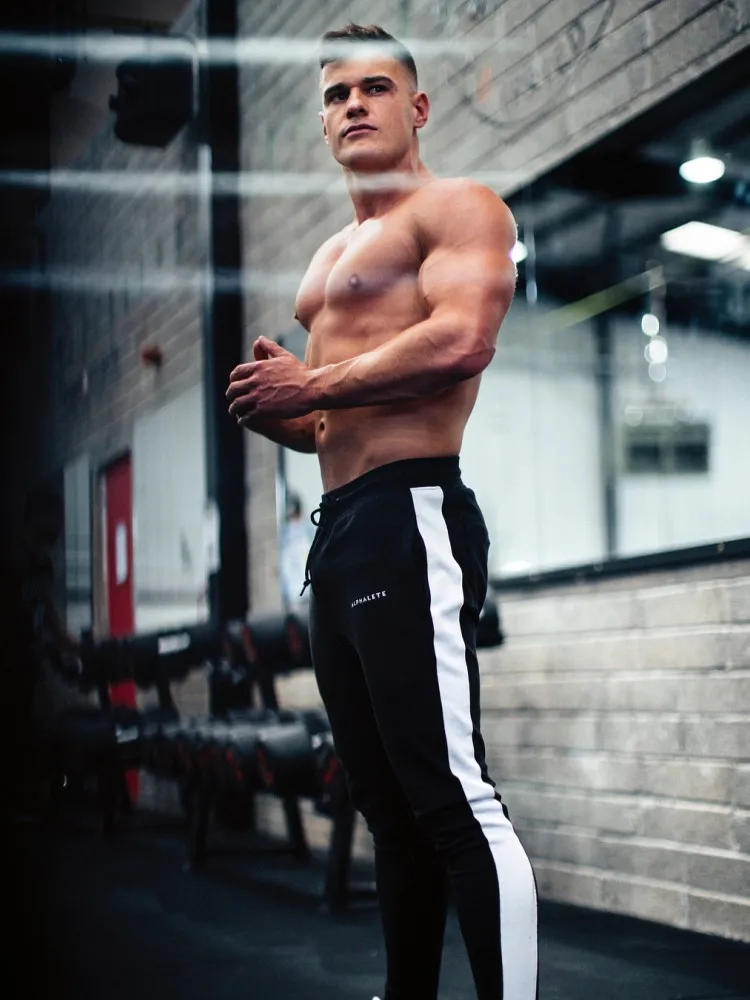 Alphalete رجل ركض سراويل تقليدية اللياقة البدنية الرجال الرياضية رياضية القيعان نحيل Sweatpants السراويل صالات رياضية عداء ببطء السراويل الترنك