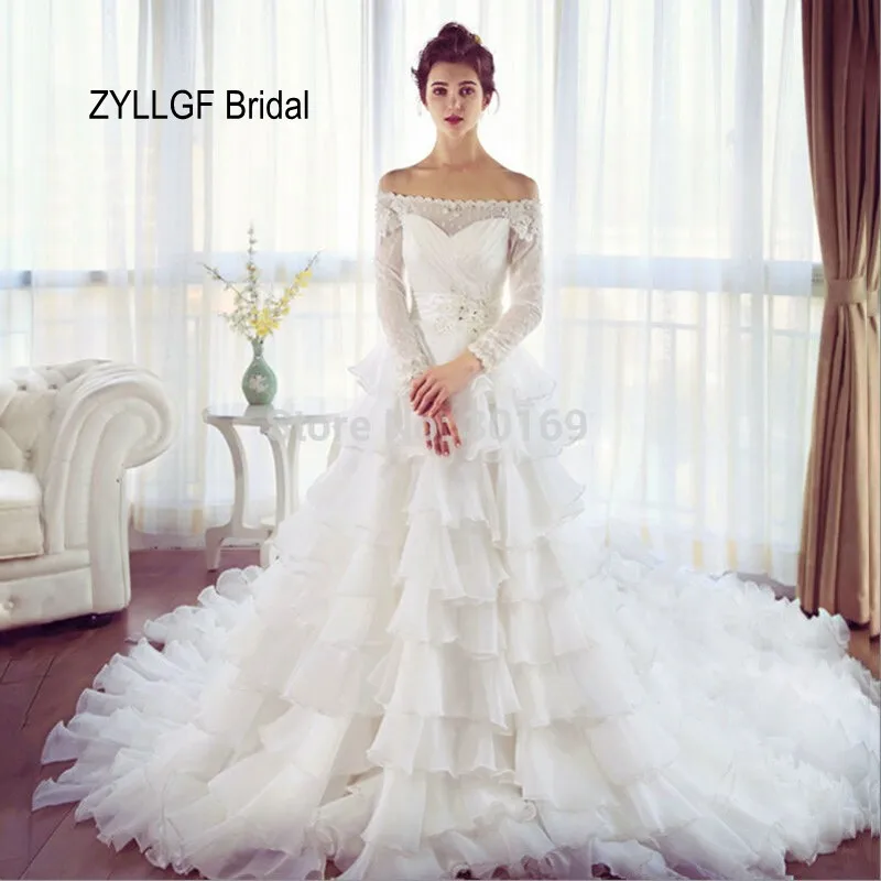 Wedding dress with long sleeves and ruffle bottom top