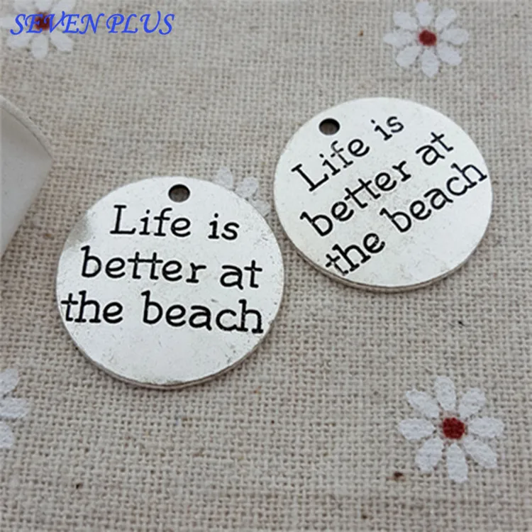 

Top Quality 20 Pcs/lot Diameter 23mm Life is better at the beach Antique Silver Round Disc Quote Message Charms Pendant