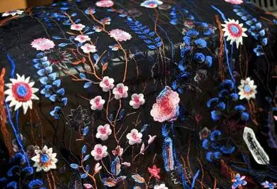 

blue floral lace fabric with mixed colors flowers and leaves, black netting fabric