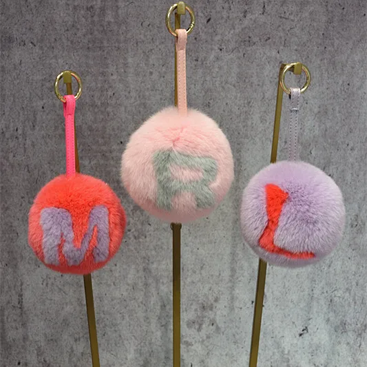 

Hot real fur ball key chains genuine rex rabbit round Personality name letter pompom soft women's bag pendant A to Z Wholesale