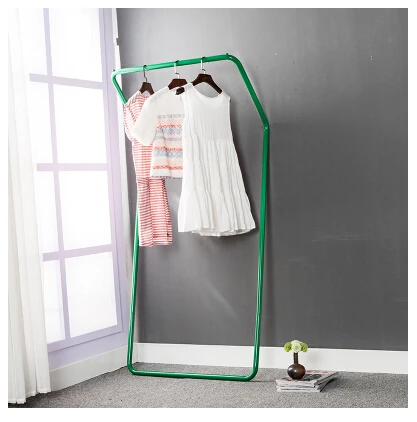 Display stand. Colorful floor against the wall. Hanger. Clothing. Clothes tree.