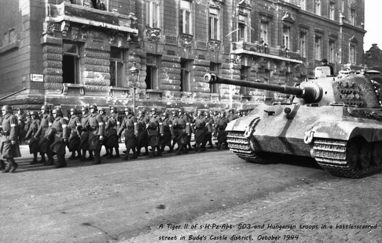 A-Tiger-II-of-s.H.Pz.Abt.-503-and-Hungarian-troops-in-a-battle-scarred-street-in-Buda's-Castle-district,-October-1944