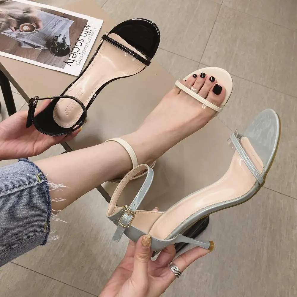 

2019 new stiletto heel patent leather round head hollow buckle color matching ladies sandals
