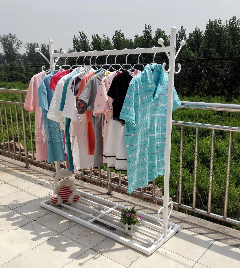 European indoor room, wrought iron hang clothes tree. Hangers. Clothes