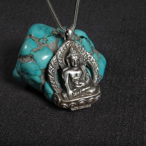 Silver necklace with tibetan charm