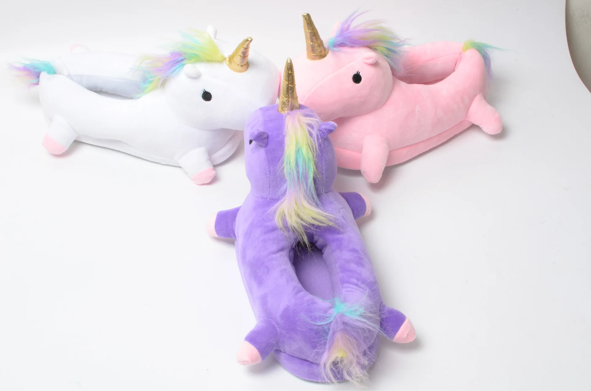 Three Unicorn Slippers Facing Each Other