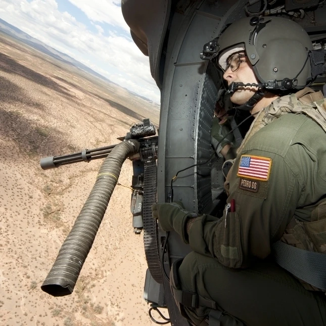 A student learns the art of aerial gunnery in an HH-60G Pave Hawk Poster Print (17 x 11)