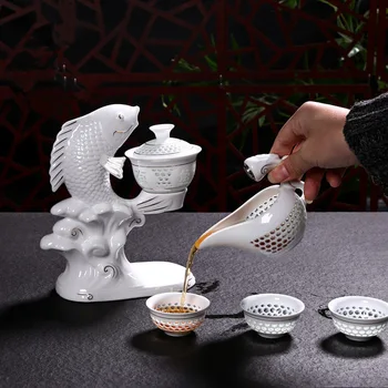

New Jingdezhen Fish Porcelain Dehua Kung Fu Tea Set Cups Automatic White Ceramic Hollow Transparent Blue and White Tea Pot Cup