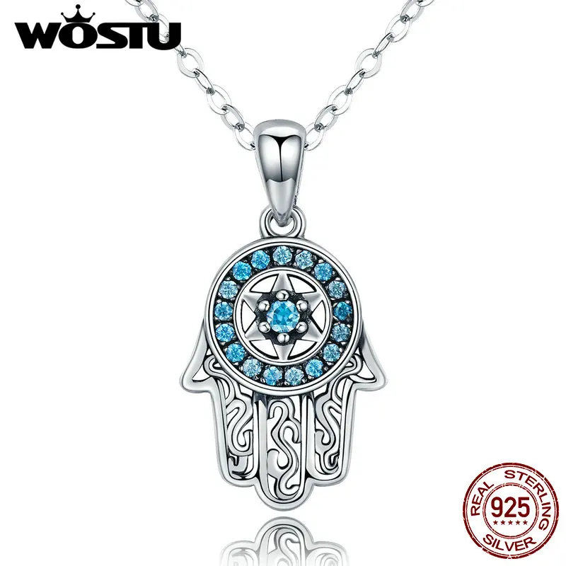 Close-up of a silver Hand of Fatima Hamsa pendant with intricate detailing and an eye symbol at the centre, displayed against a rustic medieval-style background.