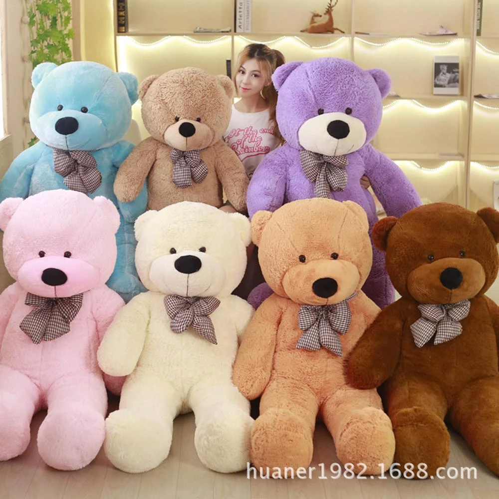 girl hugging giant teddy bear