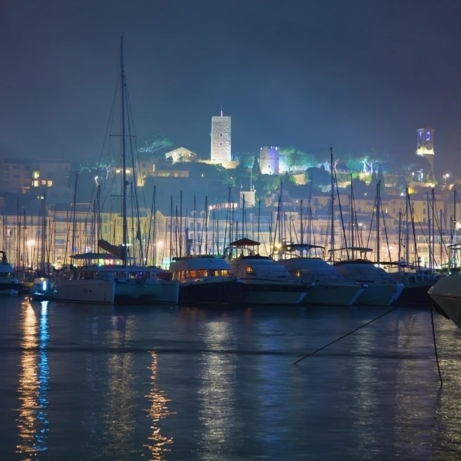 Cannes  Provence  France; Buildings Illuminated On Shore And The Harbor At Night Poster Print (38 x 24)