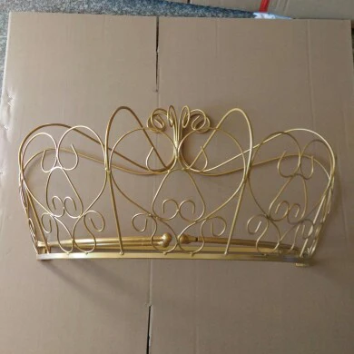 gold and white mosquito net adorns the crown shelf