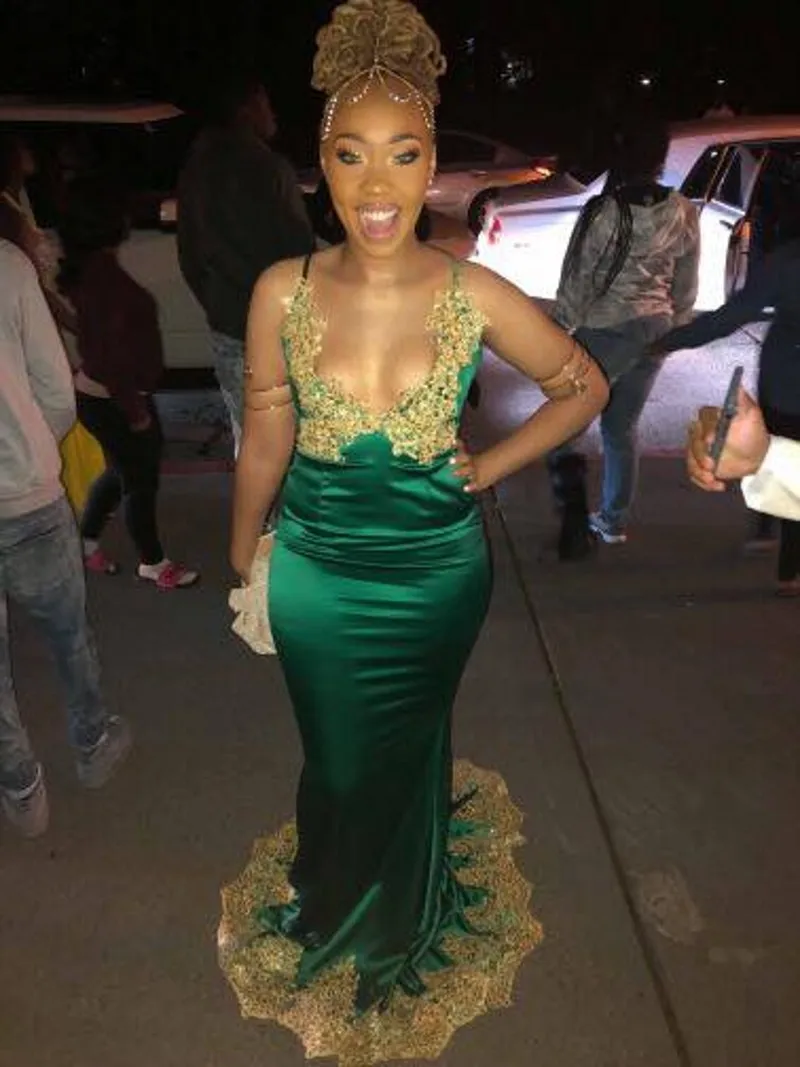 black dress with emerald green accessories