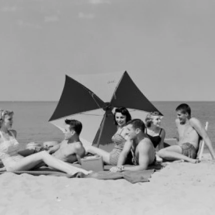 Young people relaxing at beach Poster Print (24 x 36)