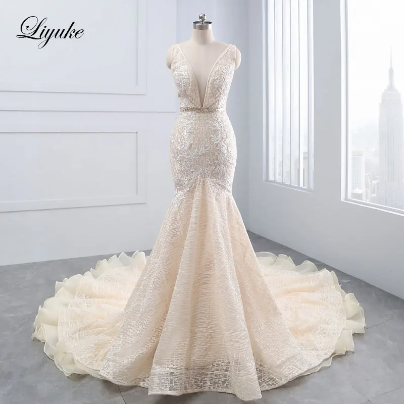 

Liyuke Tiered Ruffles Organza Deep V-neck Mermaid Wedding Dress Unique Appliques Lace Sleeveless Backless Trumpet Bridal Dresses