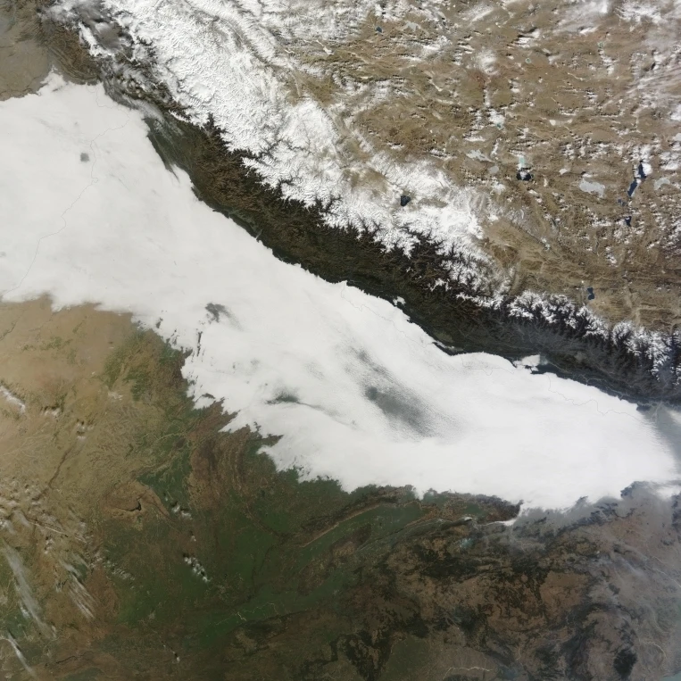 A thick bank of low clouds covers the foothills of the Himalayan mountains with some haze visible Print (16 x 12)
