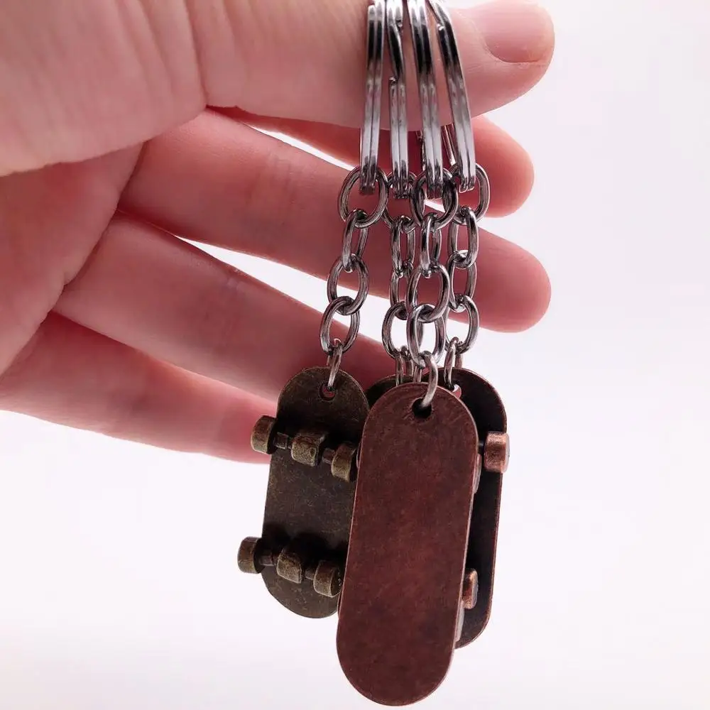 

Cute Animation Fashion Metal Keychain Keyring Mini Four Wheels Skateboard Trinket Keychains Key holder For Man And Woman Car