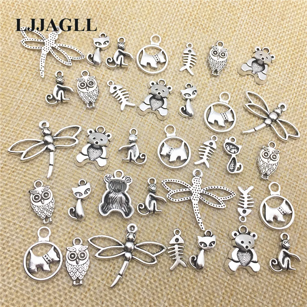 Tibetan silver dog charms crafts jewellery making 9 different designs mixed pack 