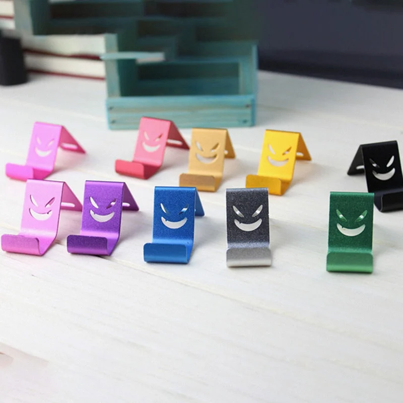 

New 1pcs Random Color Metal Devil Smile Universal Mobile Cell Phone Stand Holder