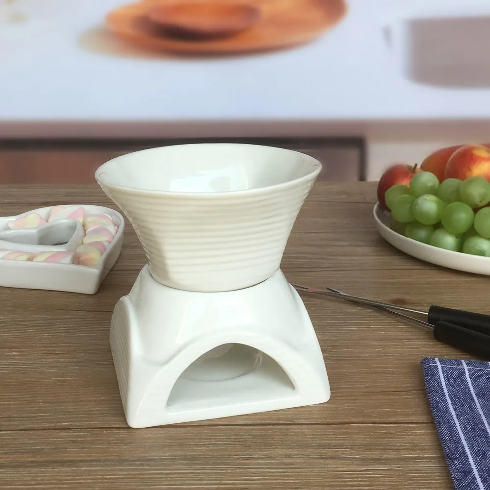 White ceramic fondue pot for chocolate and cheese melting