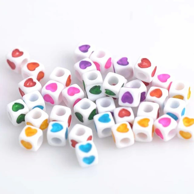 White mix of plastic beads 7x5 mm with letters