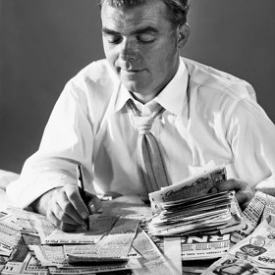 Close-up of a businessman writing on newspaper cuttings Poster Print (18 x 24)