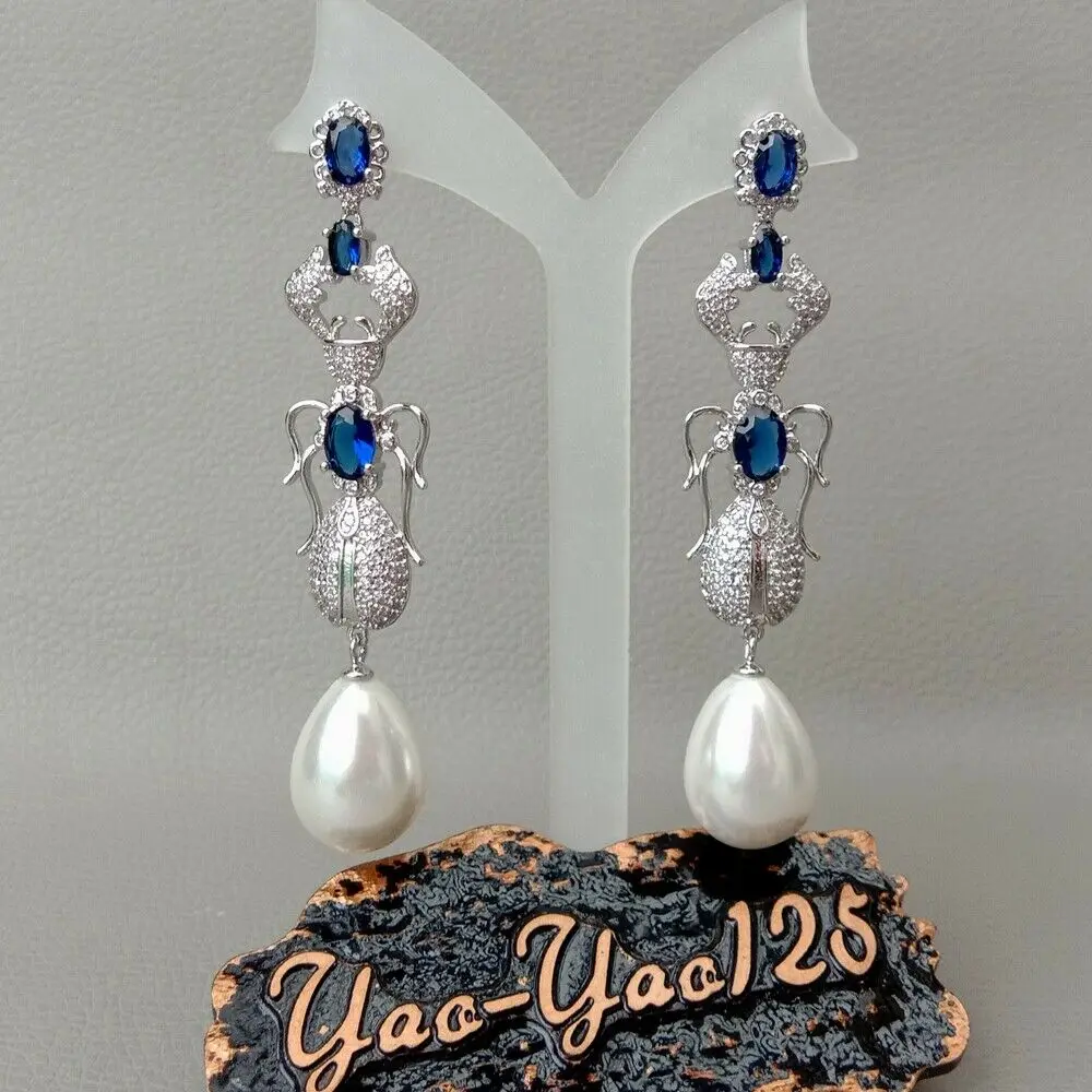 

Teardrop White Sea Shell Pearl Blue Cz Pave Insect Earrings
