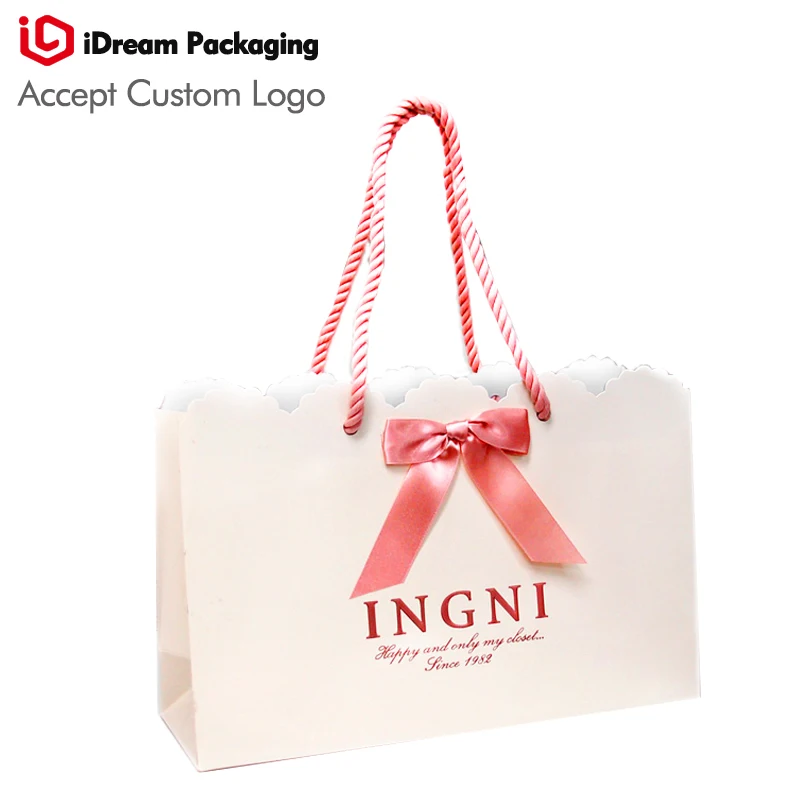 

white color pink logo Peach color ribbon bow high quality paper bag Profiled edge design fashion cosmetic packaging idream