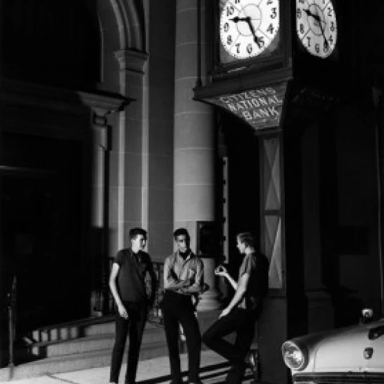 Three men having conversation outside bank at night Poster Print (18 x 24)