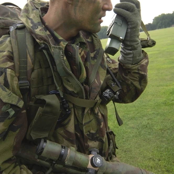 A British Army soldier radios in his location Poster Print (11 x 17)