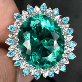 

Egg-shaped Zircon Ring with Natural Emerald Embedded