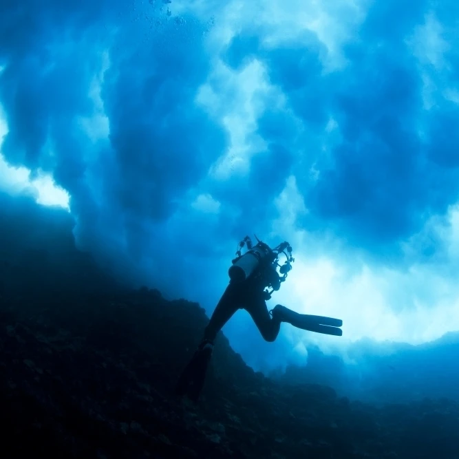 Hawaii  Lanai  Diver Near Cathedral Underneath A Billowing Wave. Poster Print (18 x 12)