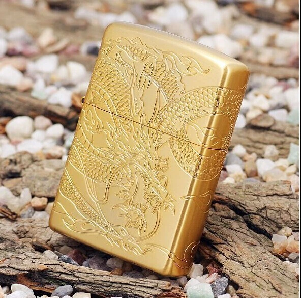 The gold plated lighter carved on all sides around the dragon dragon
