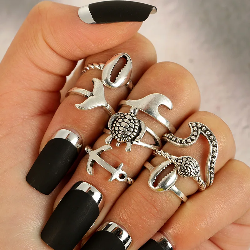 

pack of 8 creative knuckle rings with metal embossed turtle /shell /fishtail design in burnished in silver tone