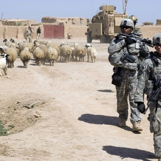 U.S. Army soldiers providing security while fellow soldiers provide humanitarian aid villagers in Shuzayf  Iraq (34x22)