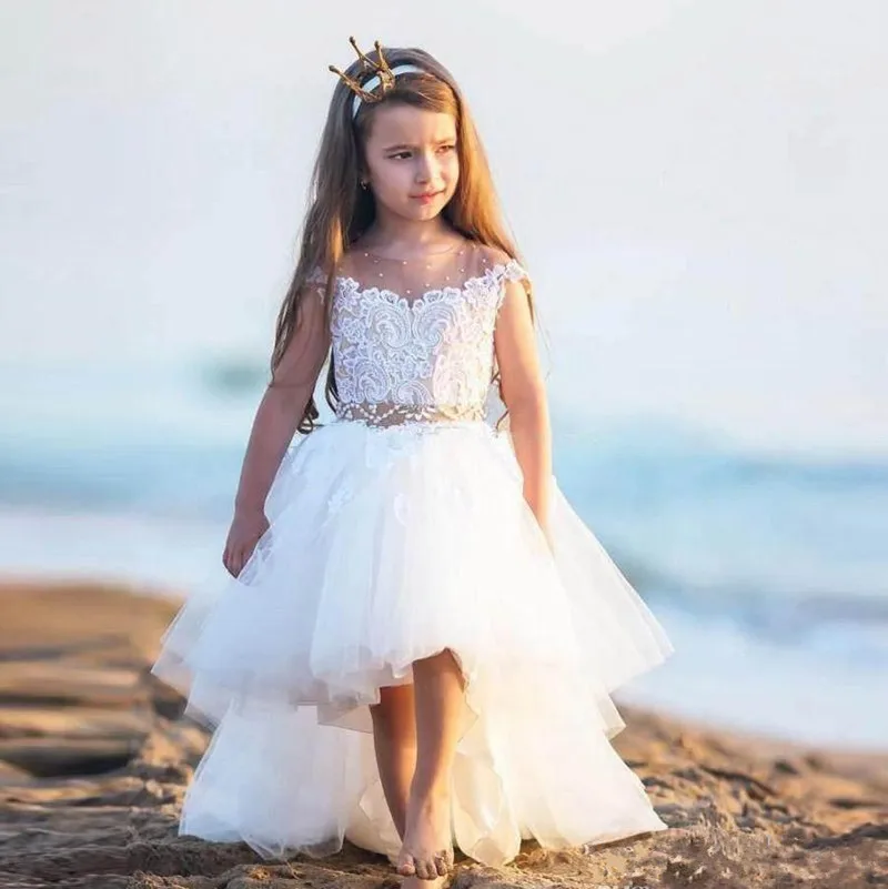 

High Quality High Low Flower Girl Dress with Beading Belt Sheer Neck Custom Made Girls Pageant Gowns Cap Sleeves Formal Wears