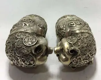 

A pair of piglets from the Chinese bank of Tibet are decorated with ornaments