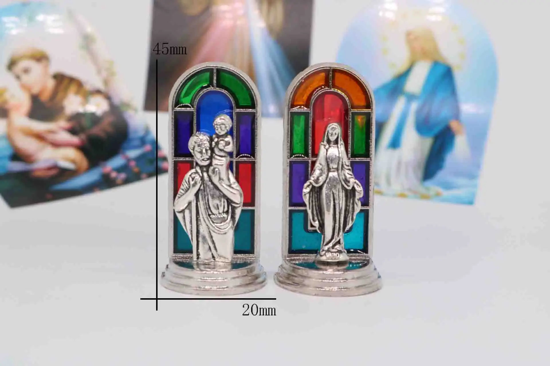 religious Jesus cross statue. Color Virgin Mary statue. Car dashboard